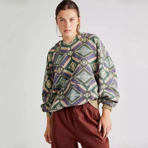 Close-up of geometric diamond print pattern on oversized hoodie with ribbed cuffs