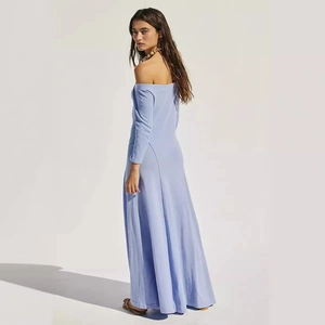 Detail of lavender off-shoulder maxi dress with long sleeves and elegant draping
