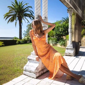 Sexy orange V-neck satin midi dress with starfish print and ruffle trim details