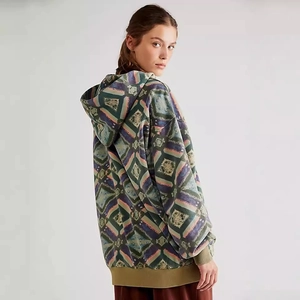 Detail of the oversized hoodie with colorful ethnic geometric print and ribbed cuffs