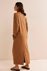 Detail of loose fit long-sleeved striped dress featuring back split and knit texture