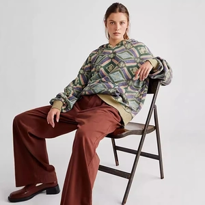 Detail of colorful geometric print hoodie with wide-leg trousers and block heel loafers