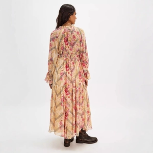 Detail of floral chiffon dress showing ruffled cuffs and elegant pink flower patterns
