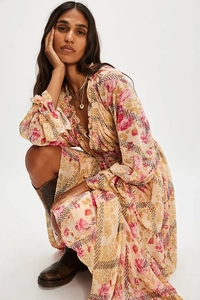 Detailed view of the V-neck ruffles and floral patterns on this bohemian chiffon dress