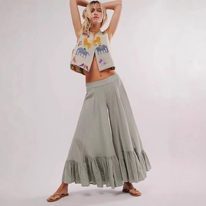 Detailed view of women's boho embroidery vest and wide-leg trousers with ruffled hem