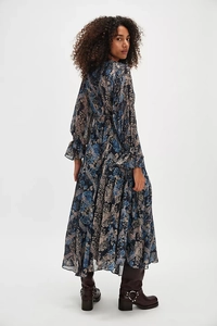 Detail view of the deep blue floral V-neck dress with layered ruffle hem and chiffon texture