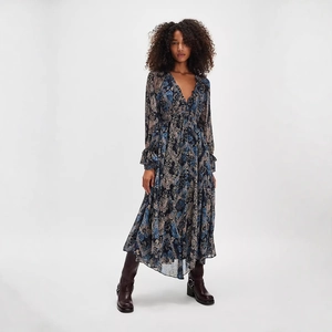 Detail of V-neck floral dress with ruffle edges and bohemian pattern on chiffon fabric