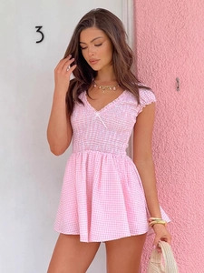 Pink and white gingham dress with smocked bodice and V-neckline tied with a white bow