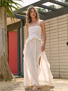 Elegant white strapless high-waist maxi dress with ruffle waist and side slit detail