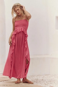 Detail of pink bohemian maxi dress with delicate ruffles and high slit on the side