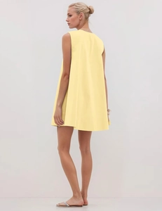 Detail view of the back and side profile of a yellow sleeveless A-line pleated dress