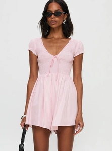 Detail of smocked elastic chest and deep V-neck with lace-up tie on pink striped romper