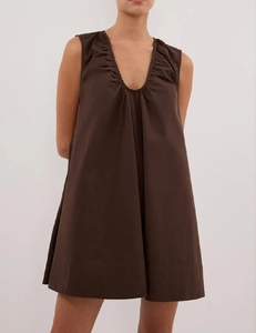 Detailed close-up of V-neckline pleats on a sleeveless brown A-line summer dress