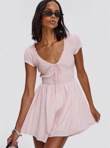 Detail of light pink dress featuring ruffled V-neckline with drawstring and smocked waist