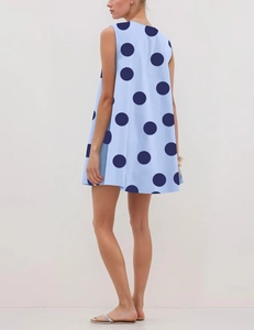Detailed view of light blue A-line dress with navy polka dot pattern and sleeveless V-neck