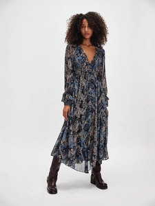 Bohemian floral maxi dress with deep V-neck and ruffled long sleeves on model