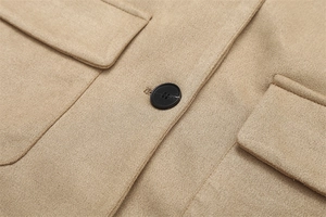 Detail of khaki faux suede jacket showing texture, black button and flap pocket seams