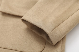 Detailed view of high-quality suede jacket stitching on khaki cuffs and pockets