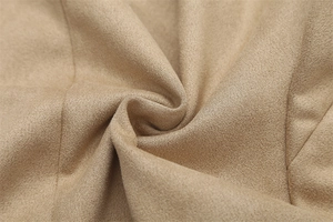 Detailed texture of camel faux suede fabric with soft brushed finish on jacket