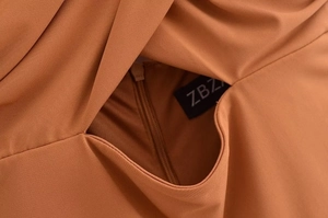 Detail view of the caramel dress showing seamless hidden zipper and ZBZA woven label