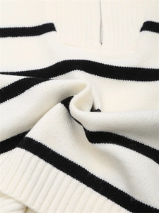 Détail d'un pull en maille avec col zippé, rayures noires et texture côtelée