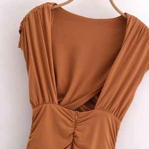 Slim fit caramel backless dress with ruched details and a deep V-neck open back design