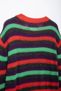 Detailed close-up of the striped knit sweater featuring red, purple and green fuzzy textures