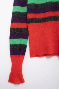 Detail of colorful striped mohair sweater showing soft knit texture and ribbed cuffs