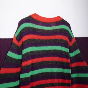 Loose fit multi-colored striped crewneck knit sweater with red, green and purple stripes