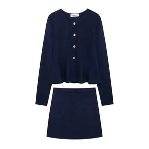 Navy knit two-piece set with long sleeve cardigan and mini skirt featuring ruffle hem