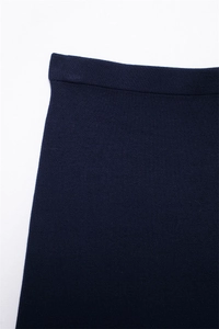 Close-up of dark blue knit skirt waist with fine texture and reinforced edge
