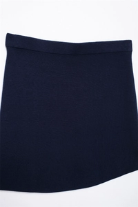Detailed flat lay of navy blue knit mini skirt showing thick texture and weave pattern