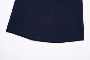 Detailed macro view of dark blue knit fabric texture and hem stitching on the winter jacket