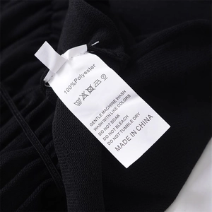 Slim fit black knitted V-neck top showing 100% polyester fabric texture and care label