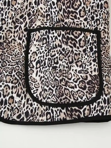 Close-up of leopard print quilted jacket featuring diamond stitching and a large front pocket