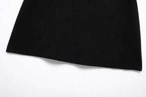 Close-up detail of the smooth hem on this black fine-knit autumn sweater or mini skirt
