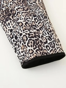 Close-up of leopard print jacket with quilted texture and black ribbed cuff detail