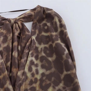Close-up of leopard print mesh fabric detail with delicate tie-up shoulder straps