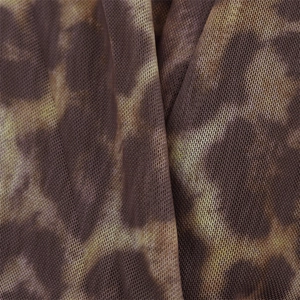 Macro detail of breathable leopard print mesh fabric with soft drape and fine textures