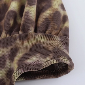 Detailed close-up of leopard print mesh fabric with pleated sleeve cuff and fine stitching