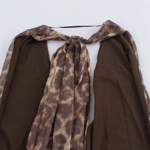Close-up of leopard print mesh fabric featuring a center knot detail and thin straps