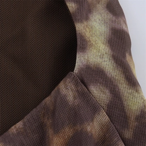 Close-up of double-layer mesh fabric with abstract brown tie-dye print and fine stitching