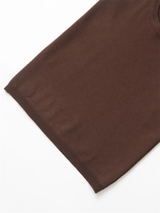 Detail shot of chocolate brown knit top showing the fine ribbed hem and fabric texture