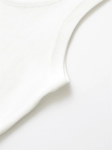 Detail of white knit vest showing ribbed neckline and fine textured cotton fabric