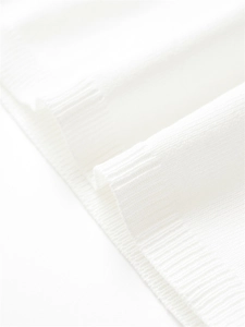 Detail of premium white fine knit fabric with professional ribbed hem craftsmanship