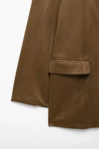 Macro shot of faux suede jacket fabric with detailed flap pocket and fine stitching