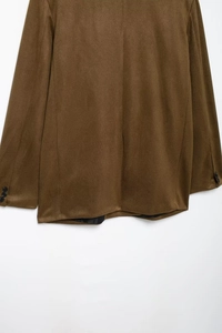 Detail view of the back seam and sleeve buttons on a brown satin finish blazer jacket