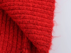 Nahaufnahme von rotem Grobstrickgewebe mit weicher Mohair-Textur und Rippmuster