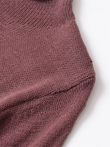 Macro shot of dark purple knit sweater showing high-quality mixed fabric and ribbed collar