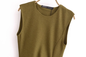 Detail view of olive green knit midi dress featuring ribbed texture and round neckline